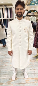 White sherwani with mandarin collar and silver buttons