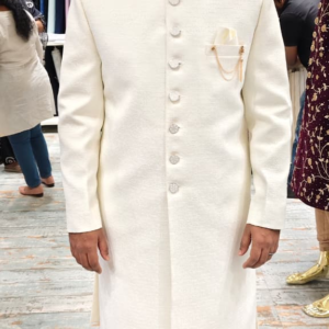 White sherwani with mandarin collar and silver buttons
